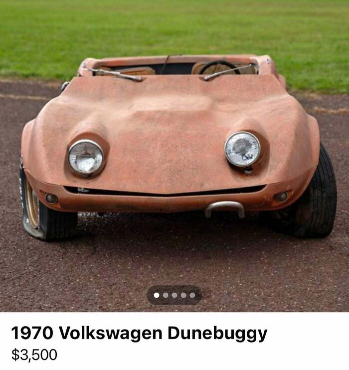 Rusty 1970 Volkswagen dunebuggy for sale on a gravel path, one headlight damaged, featured in cars of absolute chaos.