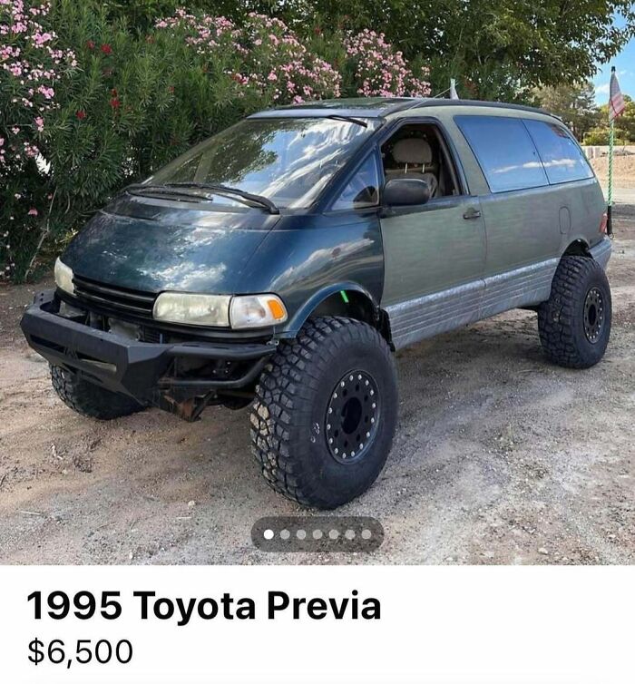 1995 Toyota Previa with off-road tires and lifted suspension, one of the chaotic cars spotted for sale outdoors.