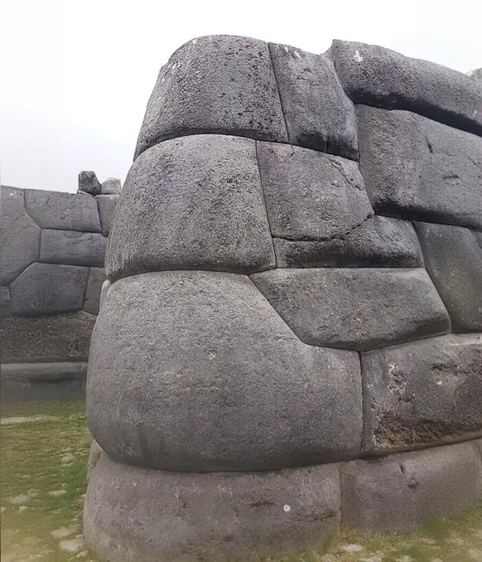 Ancient history stone wall with large interlocking rocks, showcasing impressive prehistoric construction techniques.