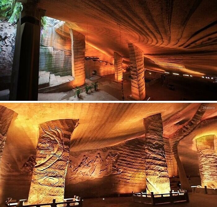 Ancient history cave with carved pillars and illuminated stone walls showcasing historical art and architecture.