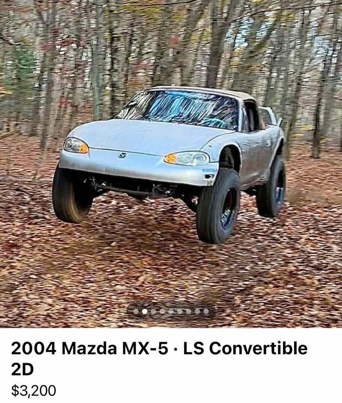 Off-road modified 2004 Mazda MX-5 with lifted suspension in a forest setting, part of cars of absolute chaos for sale.