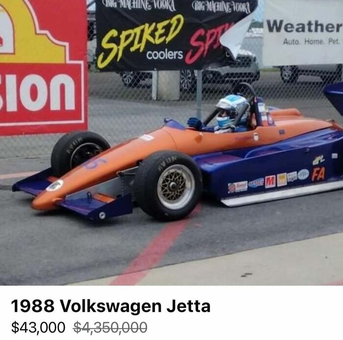 Orange and blue race car with a driver, featured among 103 cars of absolute chaos spotted for sale.
