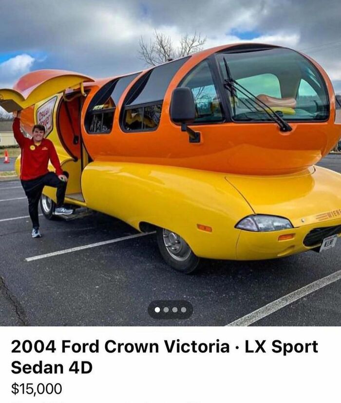 Bright orange and yellow hot dog shaped car with person posing beside it, one of the chaotic cars spotted for sale.