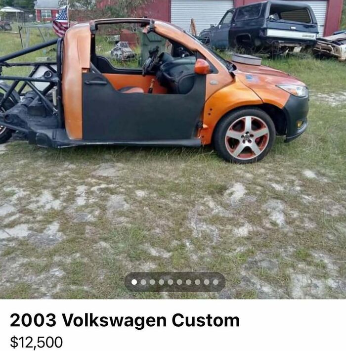 Custom 2003 Volkswagen car with missing parts and exposed frame, one of 103 cars of absolute chaos spotted for sale.