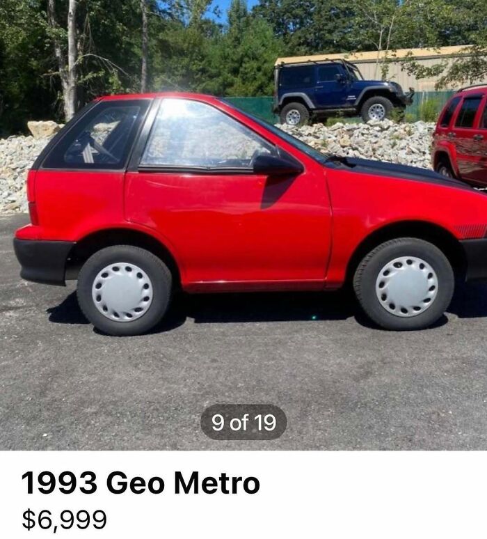 Red 1993 Geo Metro compact car parked outdoors among other vehicles in chaotic cars spotted for sale collection.