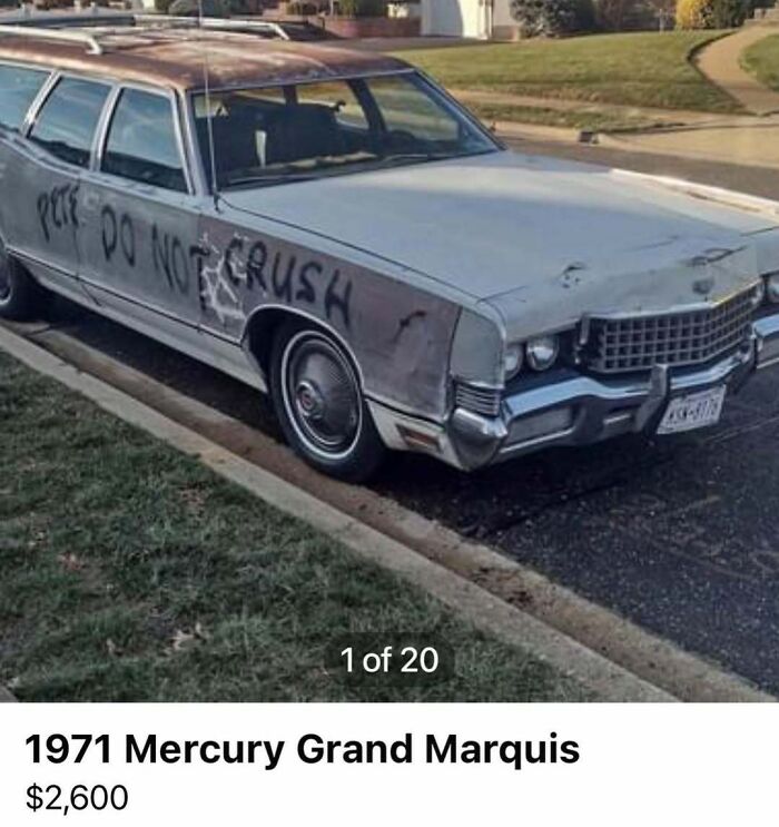 Old 1971 Mercury Grand Marquis with graffiti and dents, part of chaotic cars for sale in a suburban neighborhood.