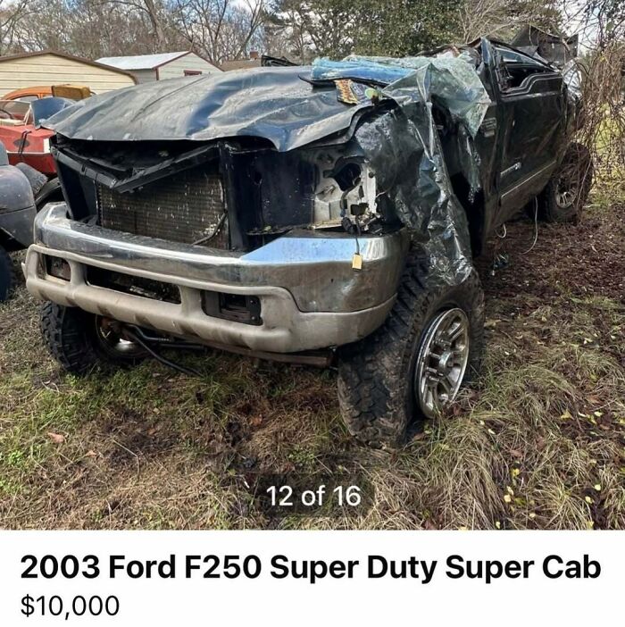 Damaged 2003 Ford F250 Super Duty Super Cab among chaotic cars spotted for sale in a grassy outdoor lot.