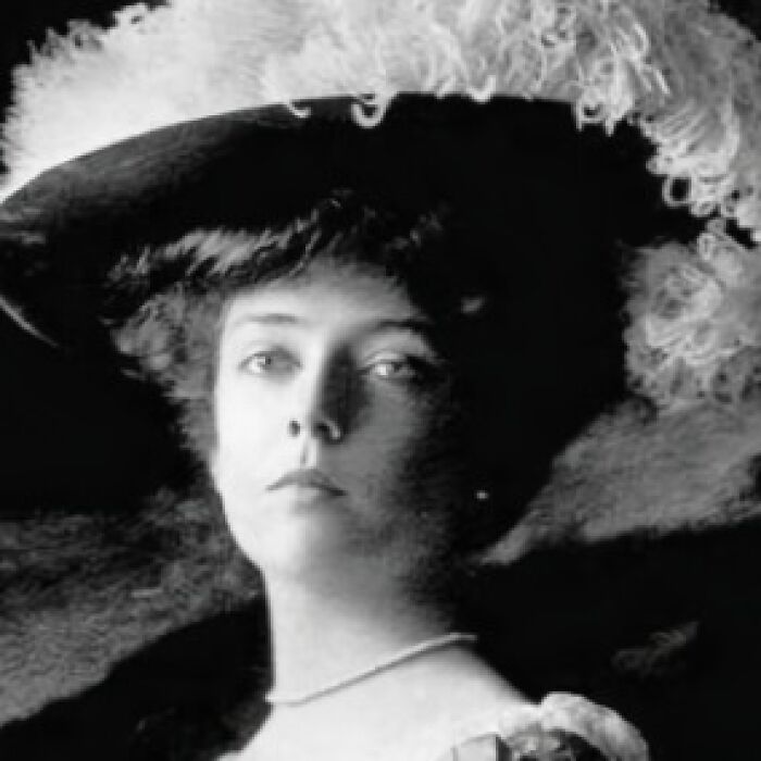 Black and white photo of Alice Roosevelt in a large feathered hat, illustrating chaotic good acts with best intentions.