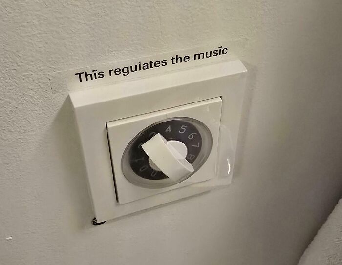 Creative hotel design decision featuring a unique music volume control dial on a wall switch panel.