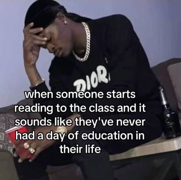 Man in black shirt and chain looking frustrated while holding a cup, representing Random Gen-Z memes about school struggles.