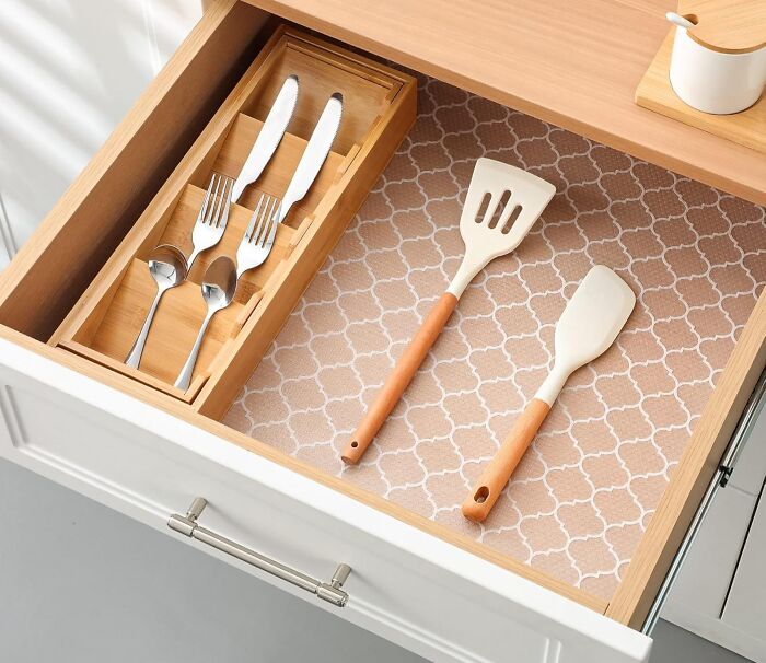 Organized kitchen drawer with wooden and metal utensils, showcasing a simple refresh for a kitchen glow-up.