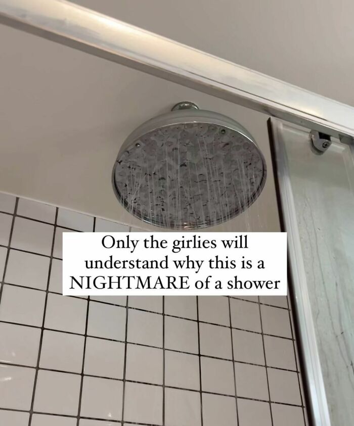 Showerhead with water running in a tiled bathroom, relatable meme about a shower nightmare for girls.