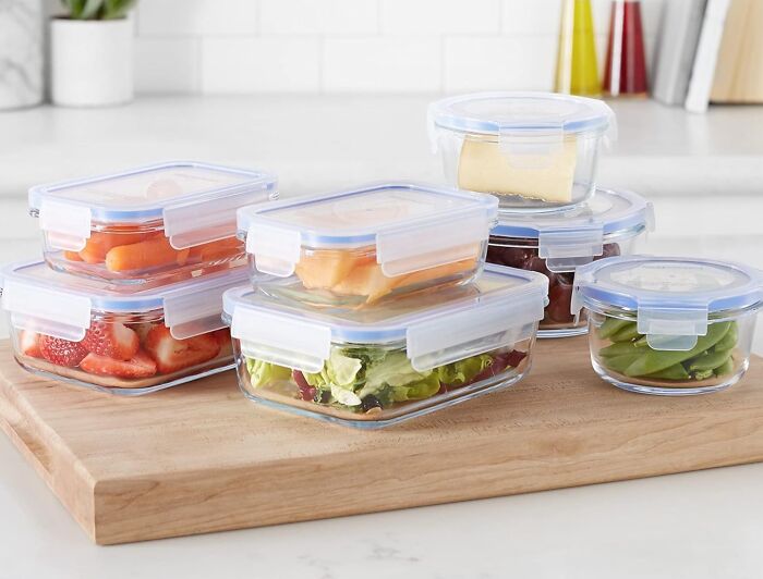 Set of airtight containers with fresh fruits and salad, ideal must-haves for an International Picnic Day feast.