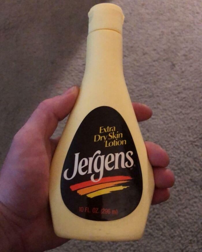 Vintage Jergens Extra Dry Skin Lotion bottle held in hand showcasing how things used to look decades ago.