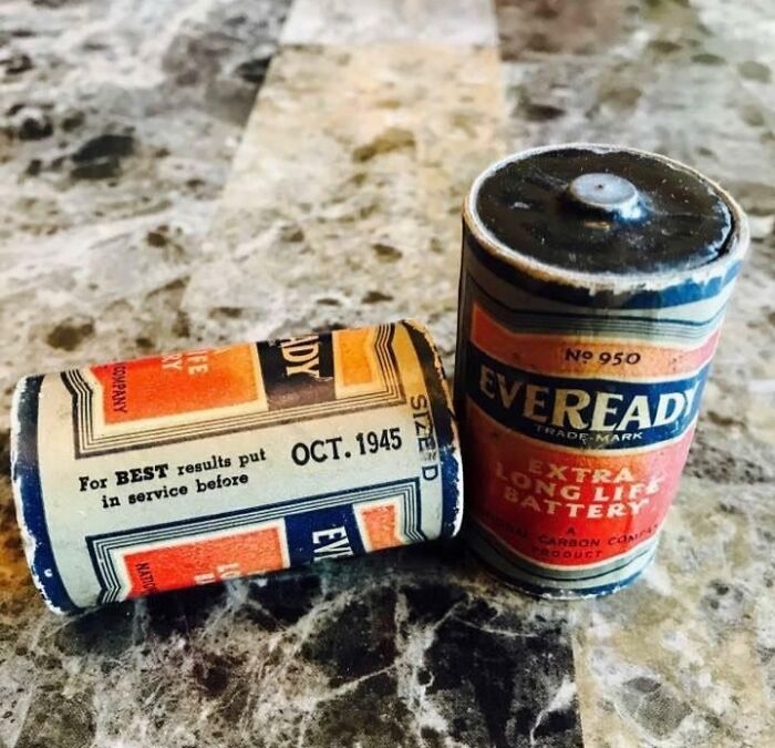 Two vintage Eveready batteries from 1945 on a marble surface, showcasing how things used to look in the past.