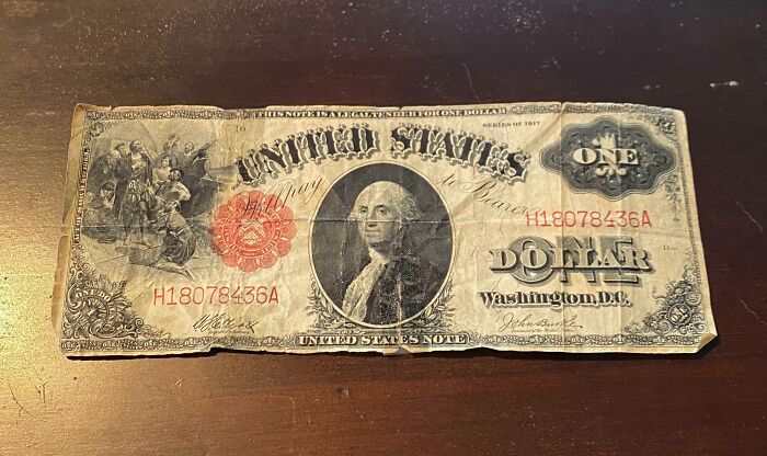 Worn vintage one dollar bill depicting how things used to look with historical design and aged paper details.