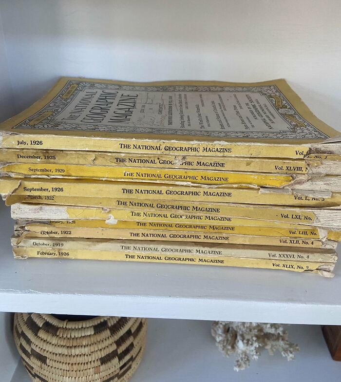 Stack of vintage National Geographic magazines from early 1900s showing how things used to look in past decades.