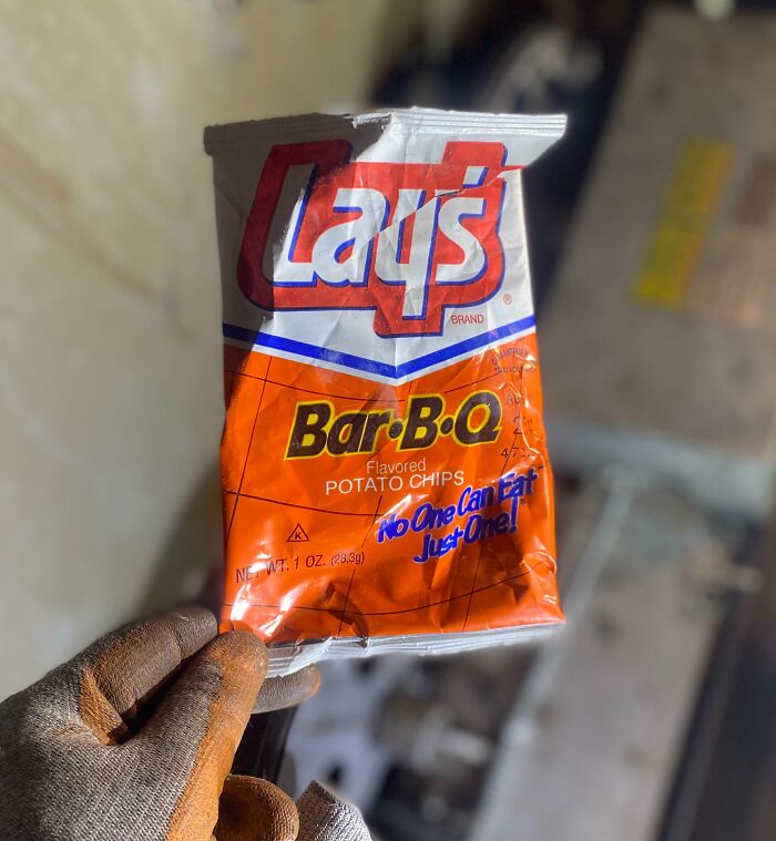 Vintage Lay's Bar-B-Q potato chips bag held by gloved hand, showcasing how things used to look in packaging design.