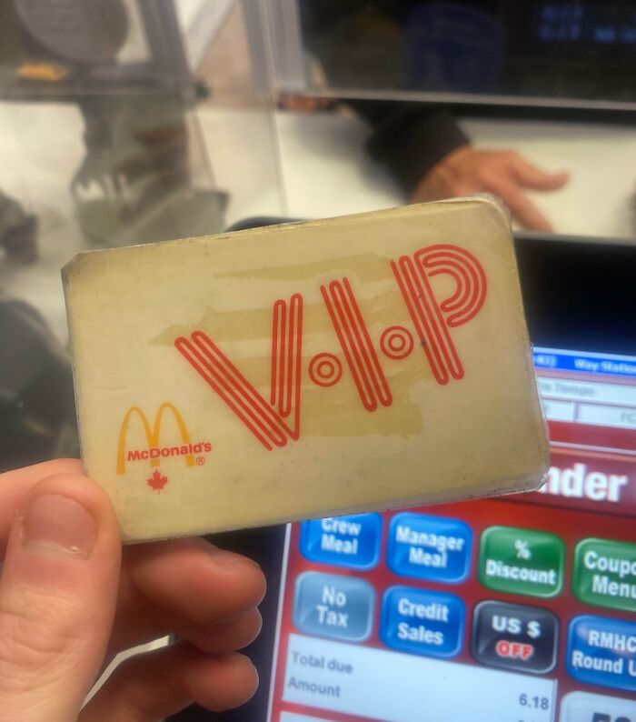 Hand holding a vintage McDonald's VIP card, showcasing how things used to look in fast food promotions.