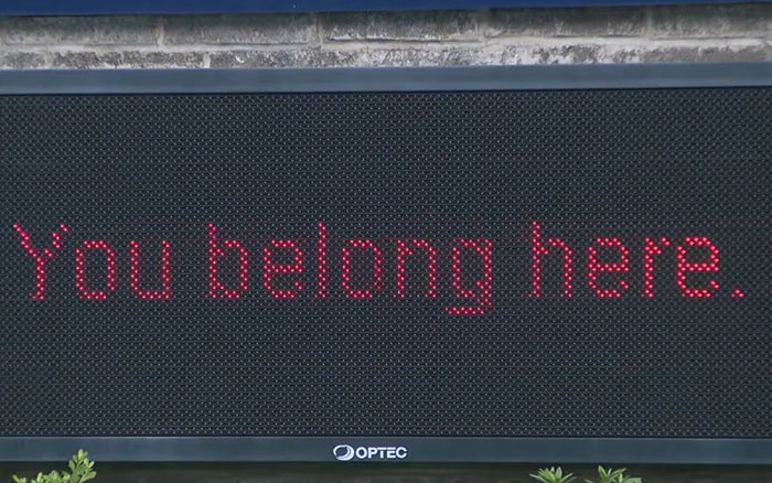 Electronic sign displaying the supportive message You belong here amid teen girl expelled over trans prom date debate.