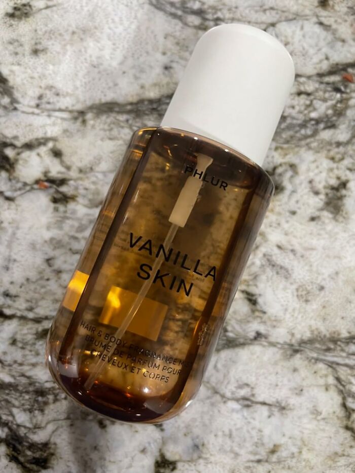 Amber bottle of Vanilla Skin fragrance mist on a marble surface, one of popular Amazon finds trending now.