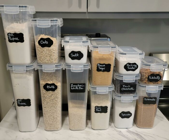 Stacked Amazon kitchen storage containers with labeled dry ingredients like oats, brown sugar, and baking soda.
