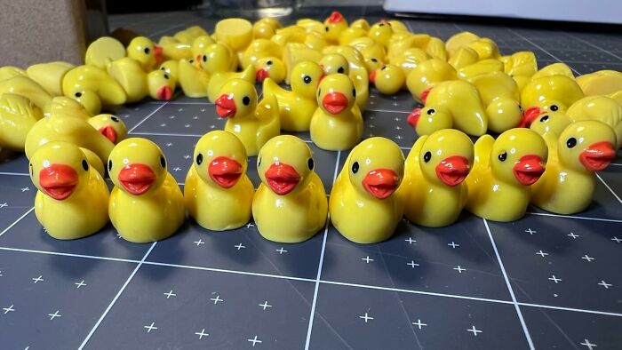 Rows of yellow rubber ducks arranged on a grid surface, featured among bestsellers pandas are buying now.