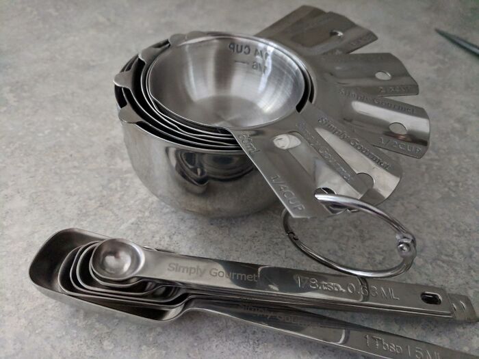 Stacked stainless steel measuring cups and spoons set, a popular Amazon find on everyone's wishlist right now.