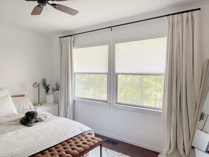 Bright bedroom with modern window treatments and cozy decor showcasing easy weekend home upgrades.