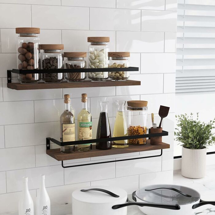Wall-mounted kitchen shelves with jars and bottles, showcasing quick home upgrades for organized weekend wins.