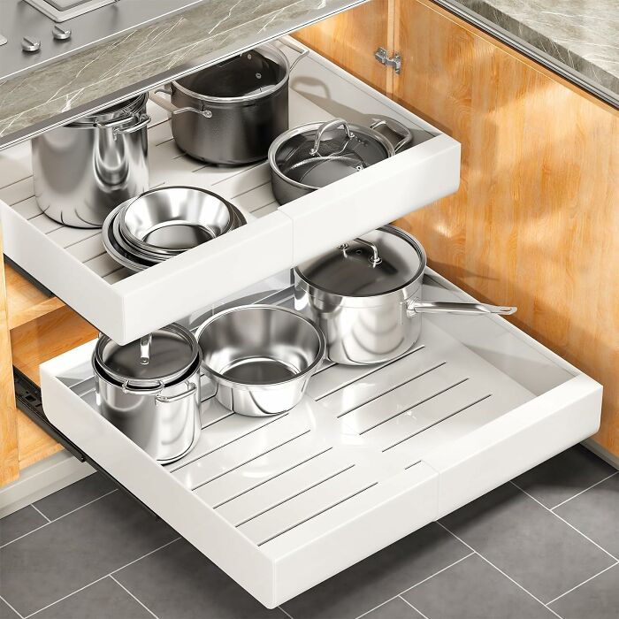Organized kitchen drawers with stainless steel pots and pans, showcasing popular Amazon finds for home and cookware.