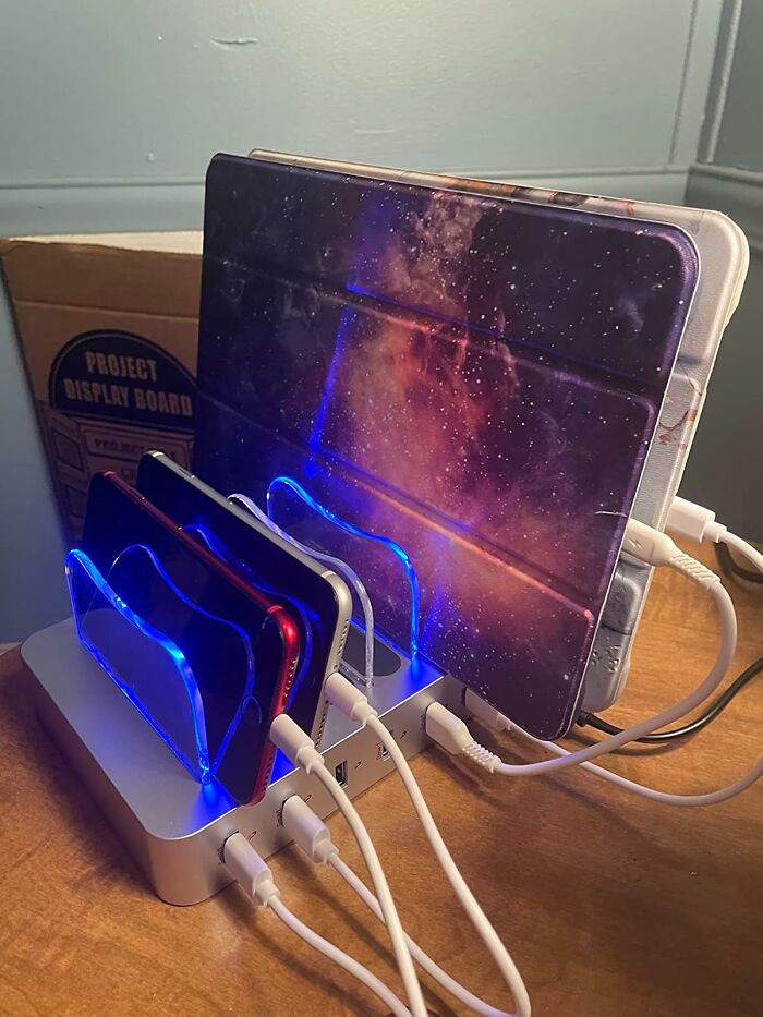 Charging station with multiple devices organized on a desk, enhancing workspace for a Monday happy place.