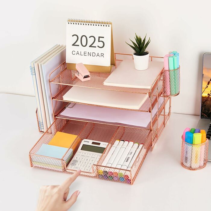 Organized desk with office supplies including calendar, calculator, markers, and file organizer for a productive workspace.