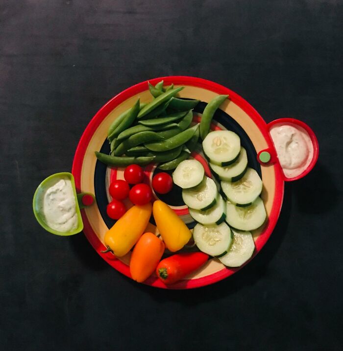 Colorful fresh veggies with dips on a plate, perfect for an international picnic day al fresco feast.
