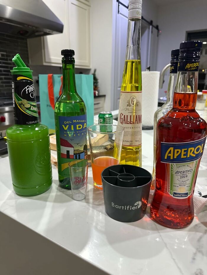 Bottles and tools for making cocktails featuring Amazon hidden gems spirits and mixers on a kitchen counter.