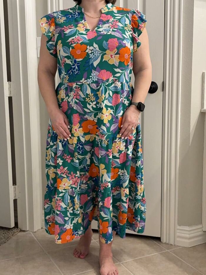 Woman wearing a colorful floral dress, a perfect Mother's Day splurge gift idea to treat yourself comfortably.