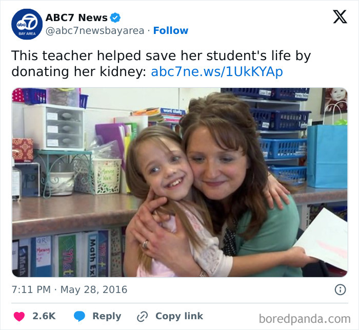 Teacher hugging smiling student in classroom, showing love and dedication to students and teaching profession.