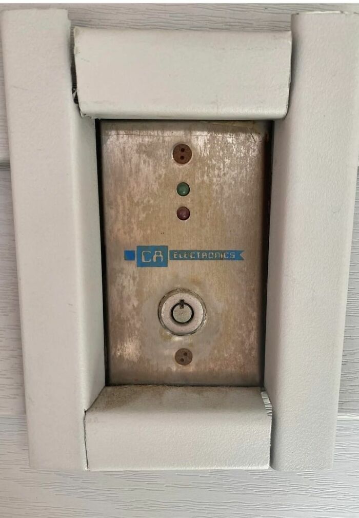 Old rusty electrical panel with faded CA electronics label and indicator lights in a home with hidden or haunted past