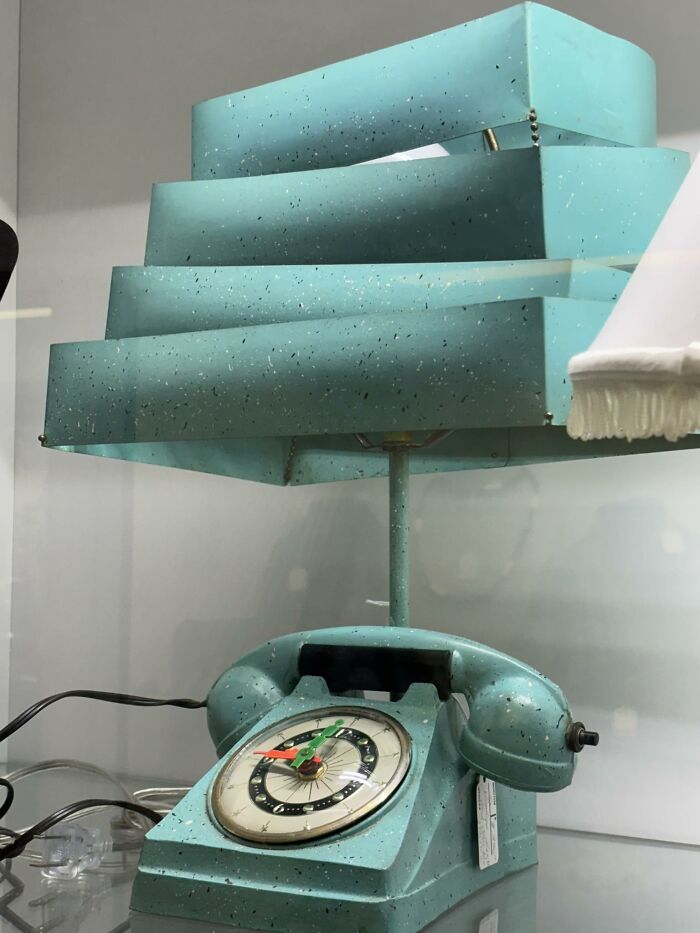 Vintage thrifted teal rotary phone combined with geometric shade lamp, a weird and wonderful retro find for collectors.