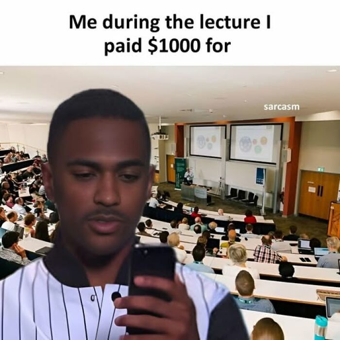 Young man distracted by phone during a lecture, highlighting hilarious memes from a popular Facebook page about funny posts.