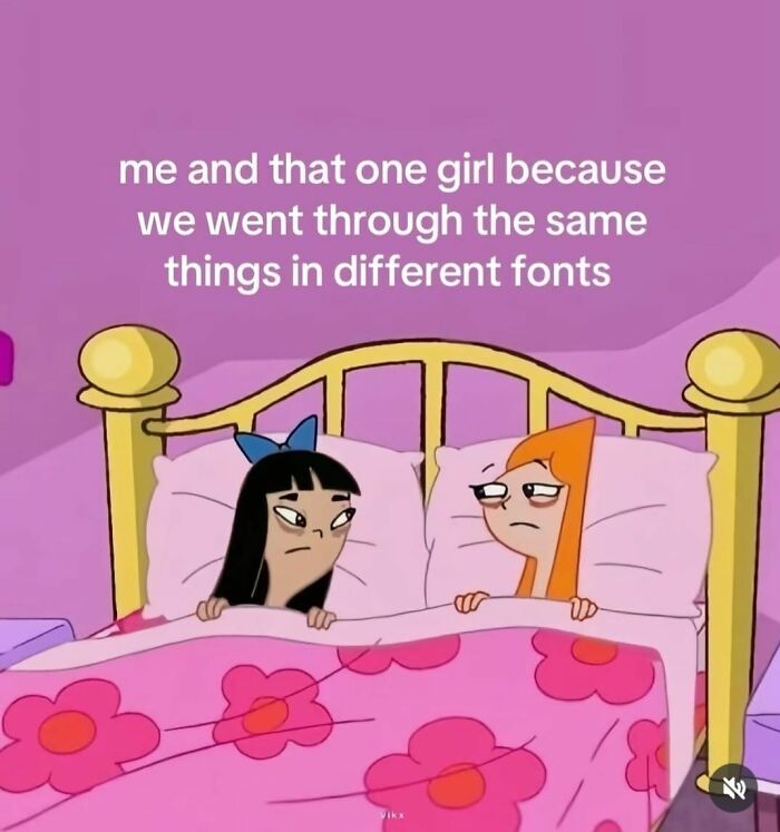 Two animated girls lying in bed with a pink floral blanket, caption about shared experiences in different fonts, cute and wholesome posts.