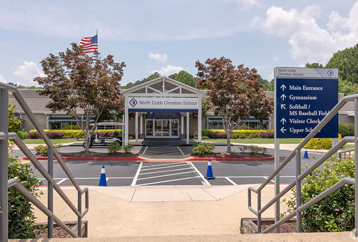 Entrance of North Cobb Christian School with signage visible, related to teen girl expelled over trans prom date debate.