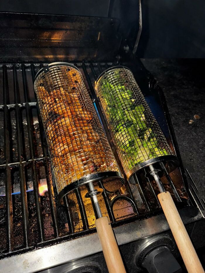 Vegetables and chicken grilling in rotating mesh baskets on a barbecue grill for Father's Day gifts.