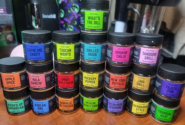 Assorted spice rubs and seasoning salts arranged on a counter, ideal gifts for Father's Day finds.