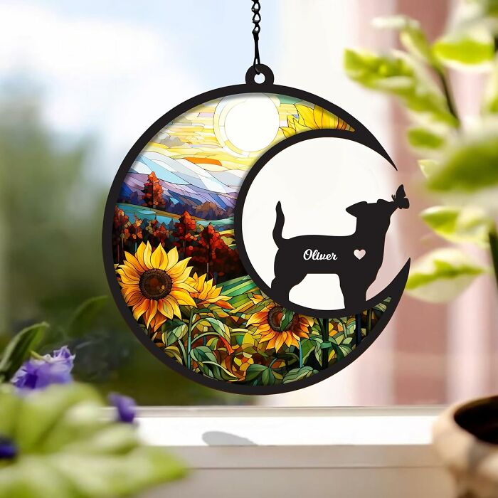 Decorative Amazon movers and shakers stained glass sunflowers and dog suncatcher hanging by a window on chain.