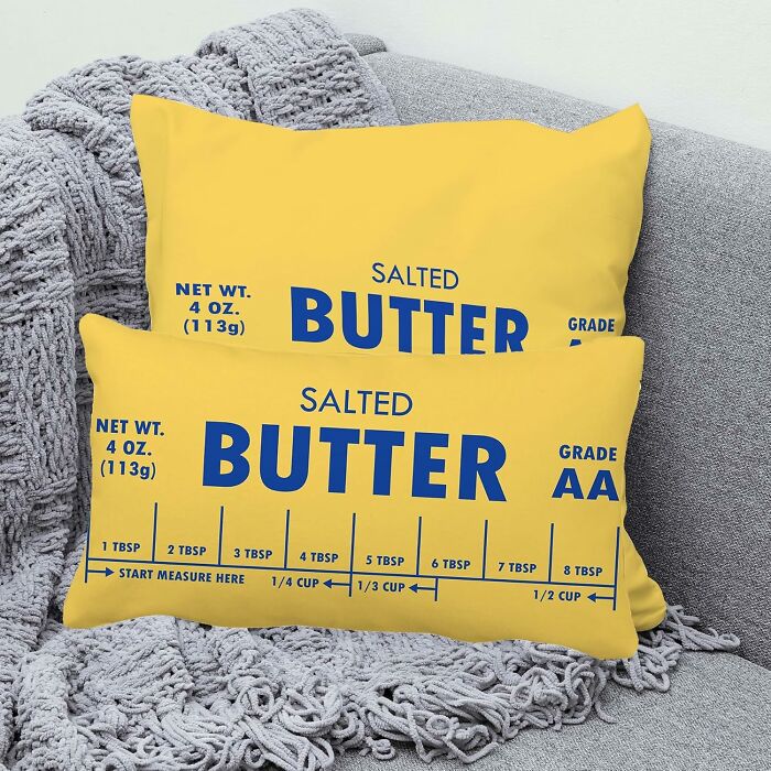 Yellow butter-themed pillows with measurement markings, showcasing weirdly wonderful finds that stand out from beige decor styles.