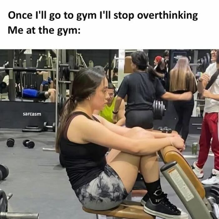 Woman sitting on a gym bench looking distracted and overthinking, illustrating gym humor from hilarious meme posts.