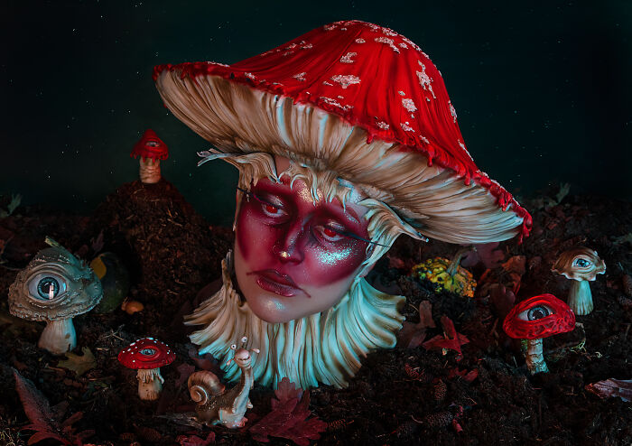 Creative makeup look featuring a person transformed into a red-capped mushroom with detailed face art and fantasy elements.