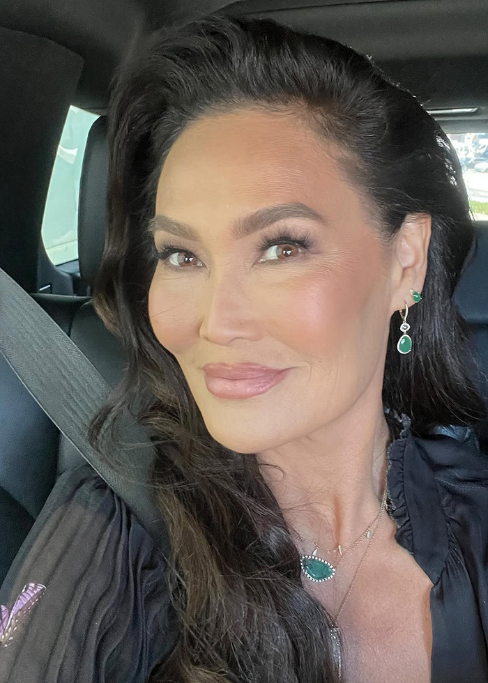 Tia Carrere close-up portrait with flawless skin and dark hair, showcasing her ageless beauty in natural light.