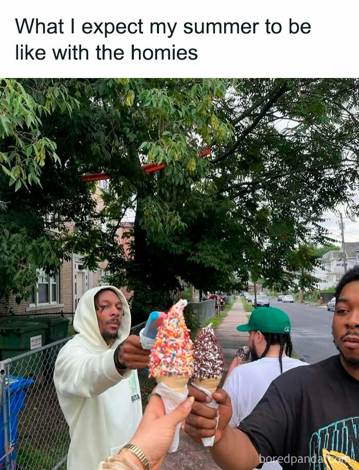 Group of friends enjoying nostalgic ’90s ice cream cones together outside on a summer day with greenery in the background.